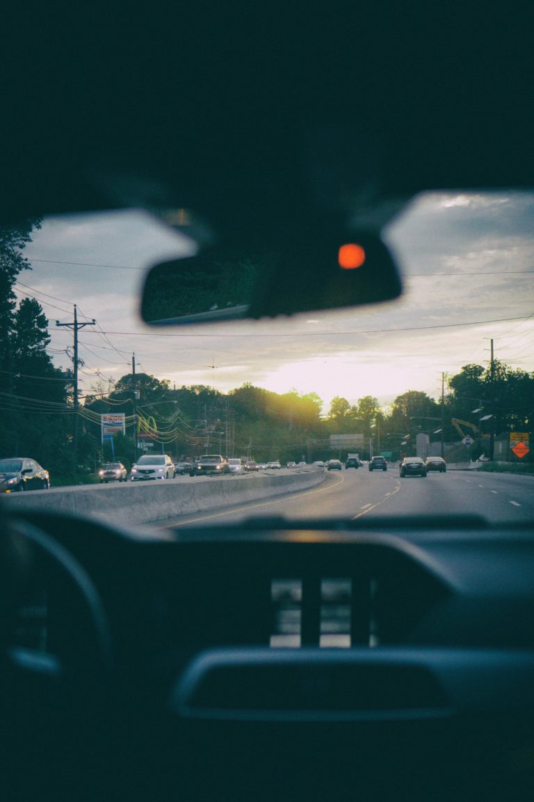 A shot of person driving taken from the interior of the vehicle