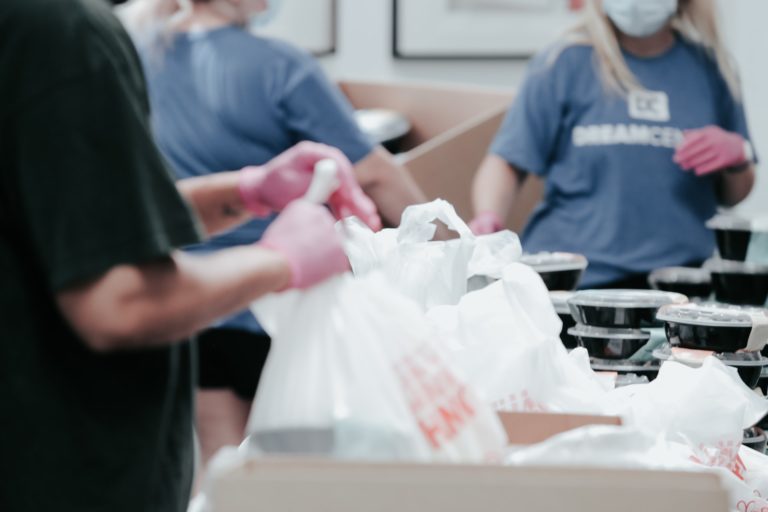 Volunteers prepare food for charity