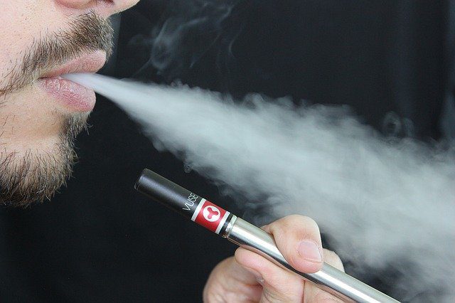 Man vaping electronic cigarette