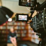 Camera filming interview in library