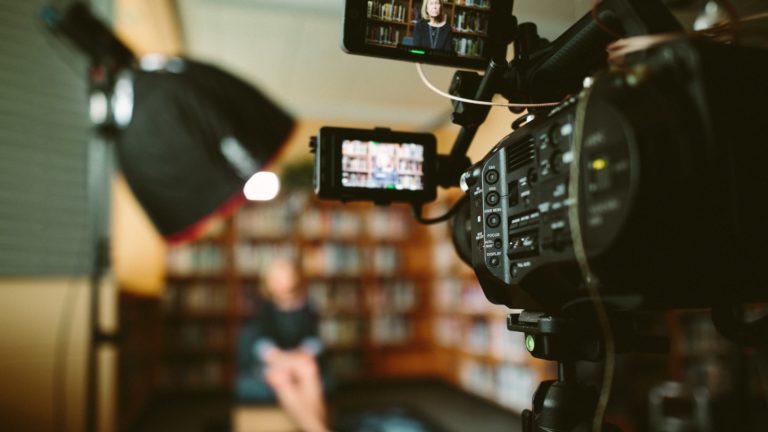 Camera filming interview in library