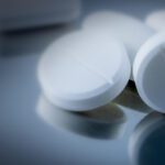 Close up on acetaminophen pills on a steel table