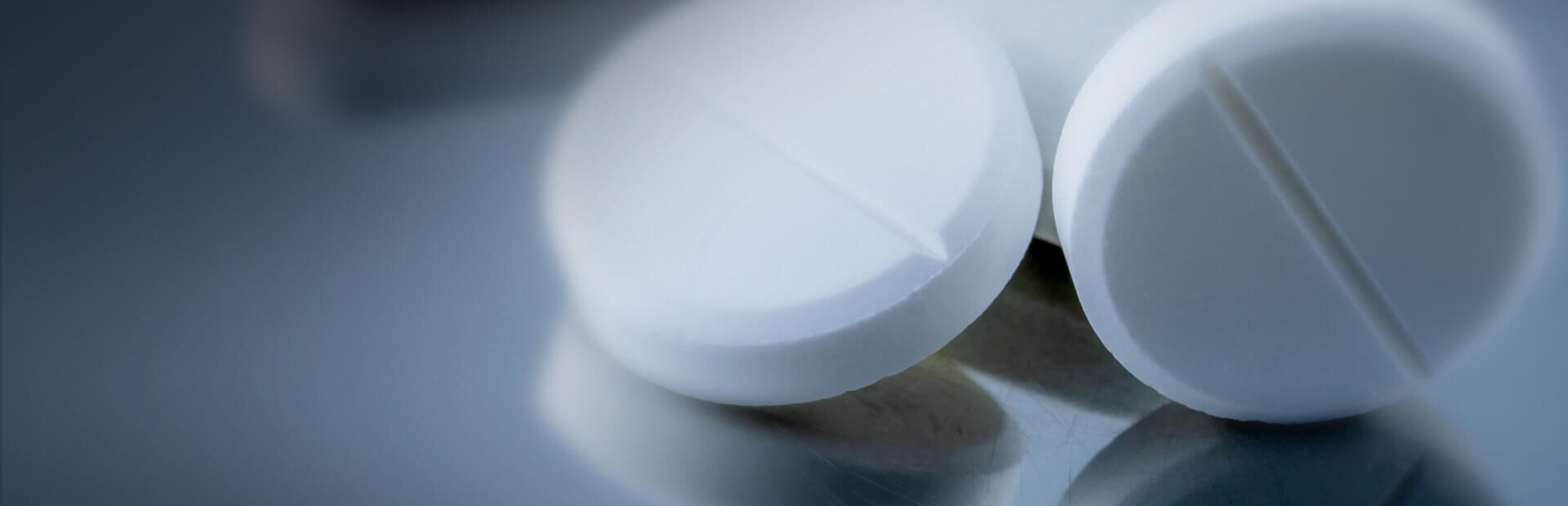 Close up on acetaminophen pills on a steel table