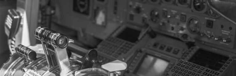 Inside of a plane's cockpit, shown in grayscale