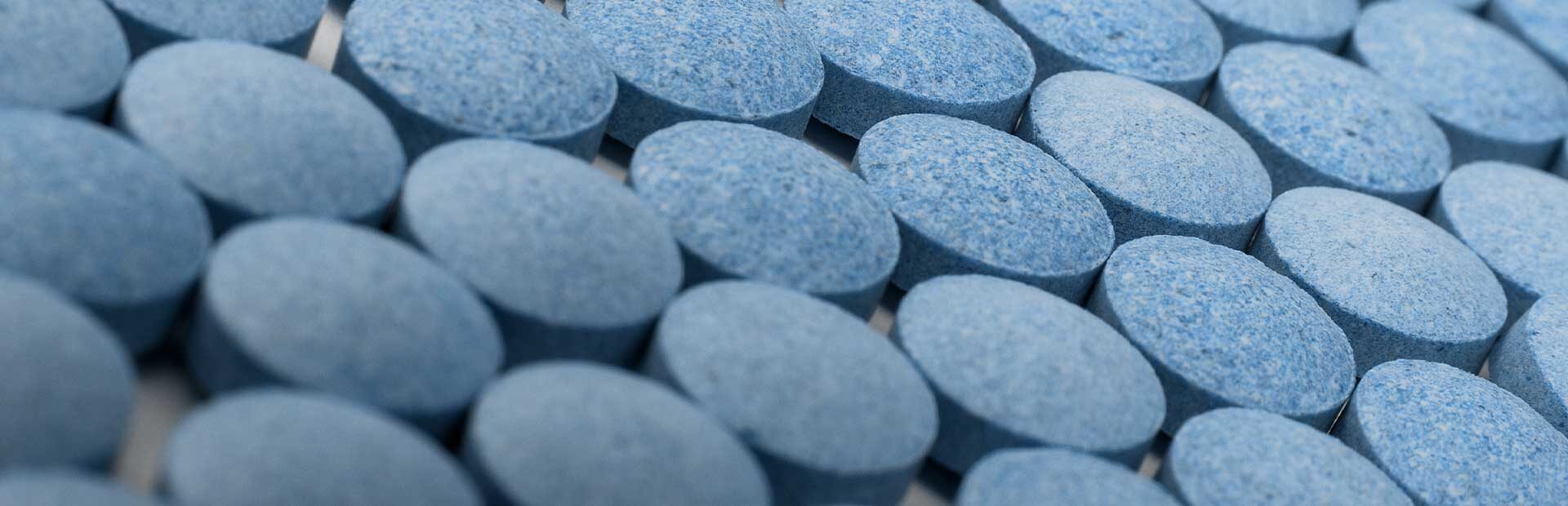 Close up of many small round blue pills