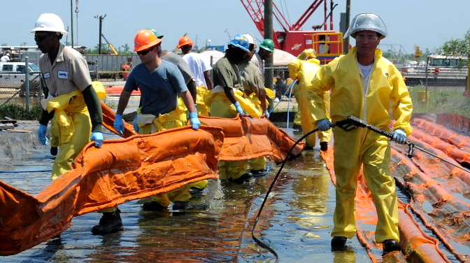 Cleanup workers deploy oil containment booms