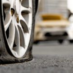 Defective Tires: Close up of a flat tire in traffic