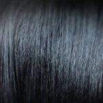 Close up of Black hair that has been treated with a chemical hair relaxer