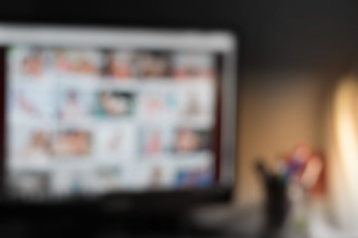 A desktop monitor displaying video website , out-of-focus