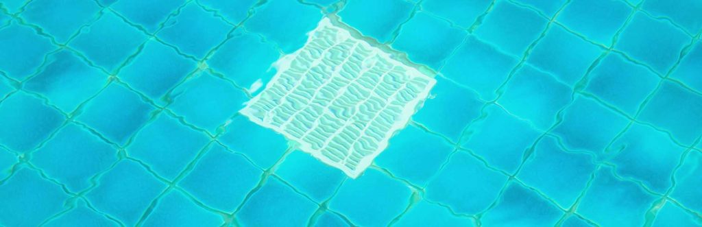 Outdoor pool with a focus on the grate in its floor