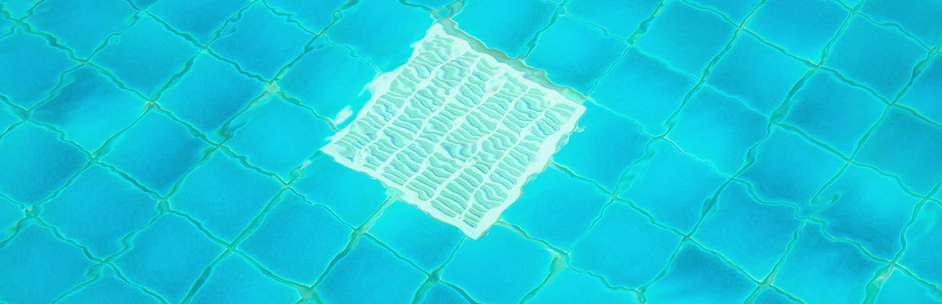 Outdoor pool with a focus on the grate in its floor