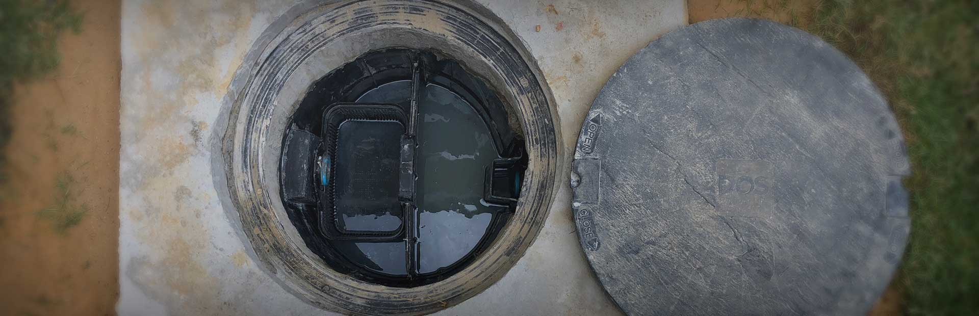 A hazardous grease trap with its lid off