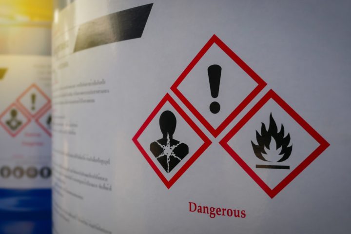 Toxic Exposure: Close up of a warning label on chemical barrel