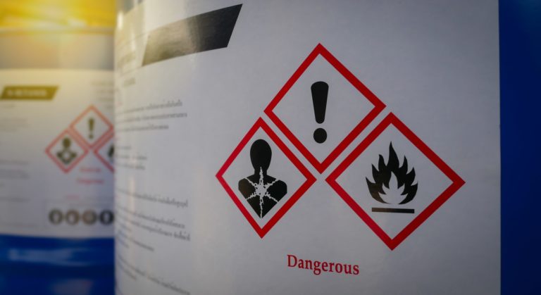 Toxic Exposure: Close up of a warning label on chemical barrel